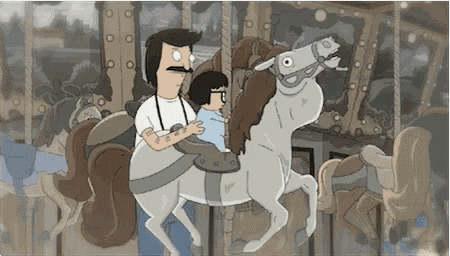 a man and a child are riding a merry go round .