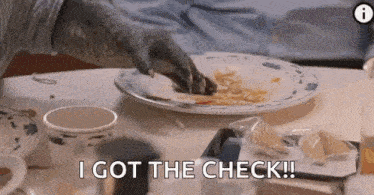 a dinosaur 's hand is reaching for a plate of food on a table .