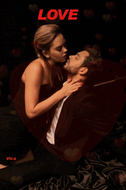 a woman kissing a man with the word love on the top
