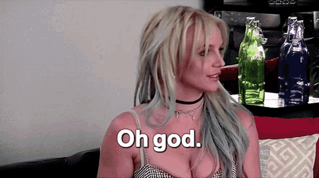 a woman sitting on a couch with the words oh god written on her chest