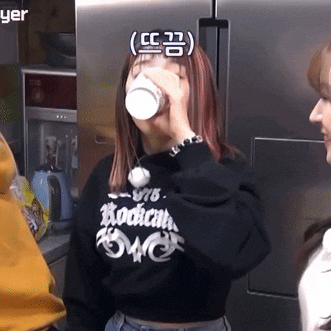a woman wearing a black sweatshirt that says rockers on it is drinking from a cup