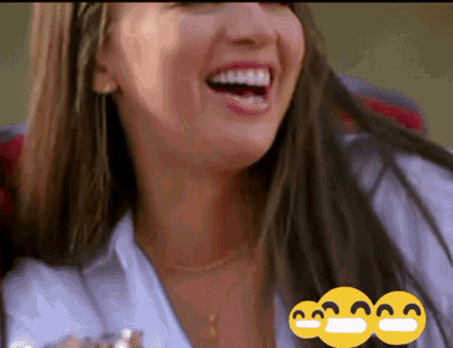 a close up of a woman 's face with three smiley faces on the bottom
