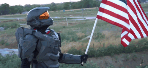 a man in a military uniform is holding an american flag