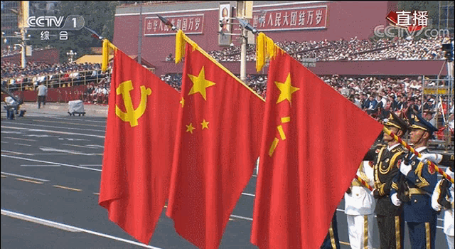 several flags are displayed in front of a crowd with cctv 1 in the corner