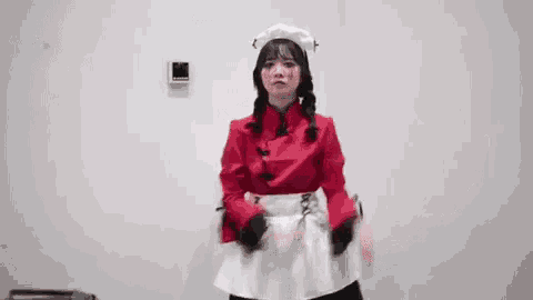 a woman in a maid costume is dancing in a room .