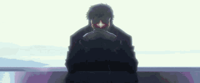 a man is sitting at a table with his hands folded and a red light coming out of his eye .