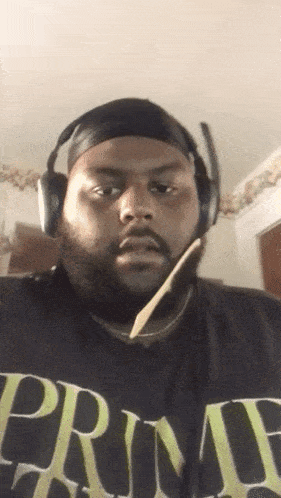 a man is wearing headphones and a shirt that says prime
