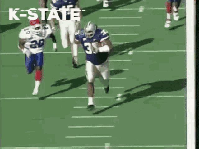 a football player with the number 30 on his jersey is running with the ball