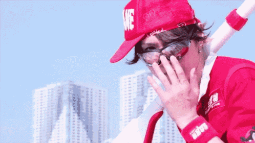 a person wearing a red hat and sunglasses with the word love on it