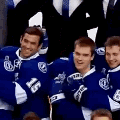 a group of hockey players are posing for a picture and one of them is wearing a jersey with the number 15 on it