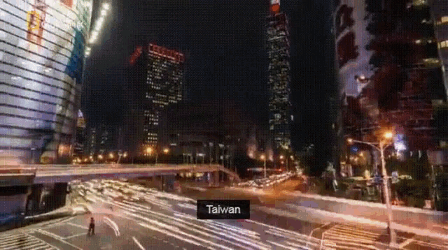 a blurry picture of a city at night with the word taiwan on the bottom right