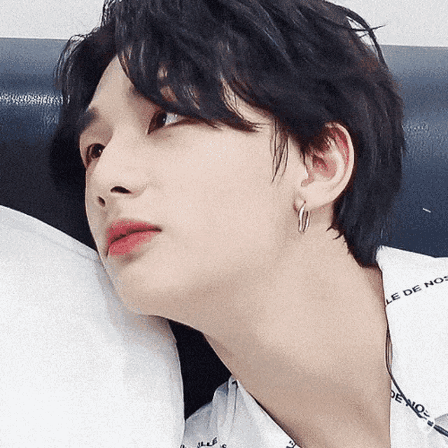 a close up of a person 's face with a white shirt that says le de nos