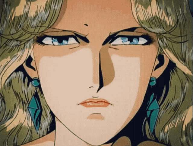 a close up of a woman 's face with earrings on