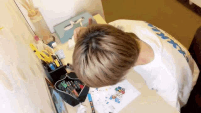 a person sitting at a desk with a t-shirt that says ' xerox ' on it