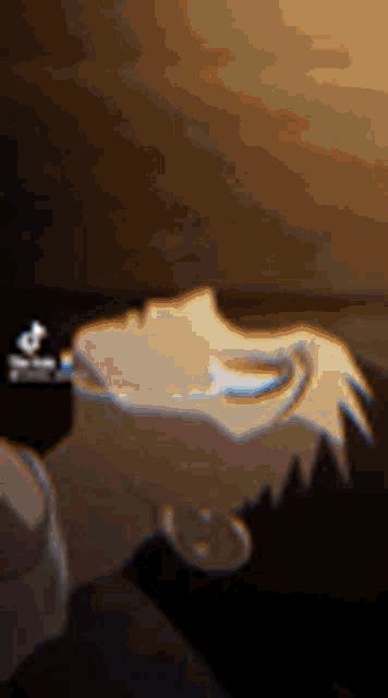a close up of a person 's face in a dark room with a blurred background .