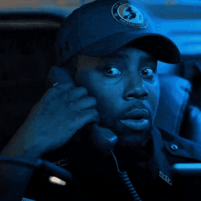 a person wearing a hat that says the witch massachusetts police