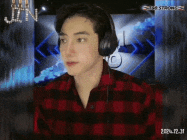 a man wearing headphones and a plaid shirt with the year 2024.12.31 on the bottom