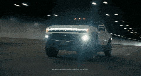 a car is driving down a dirt road and smoke is coming out of the exhaust pipe