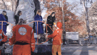 a woman in a stem uniform stands on a parade float