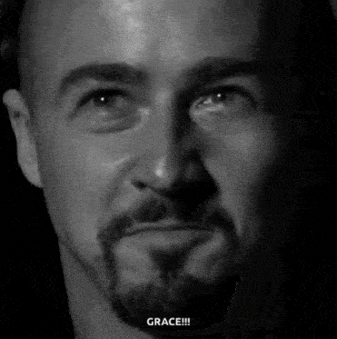 a man with a beard is making a funny face in a black and white photo with the word grace written below him .