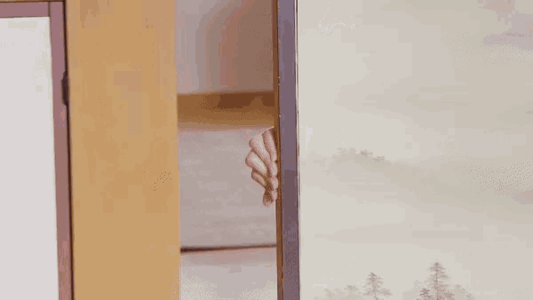 a woman is peeking out from behind a wooden door in a room .