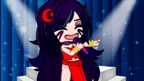 a girl is singing into a microphone on a stage .