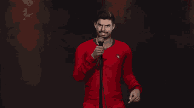 a man in a red shirt with the number 7 on it is holding a microphone