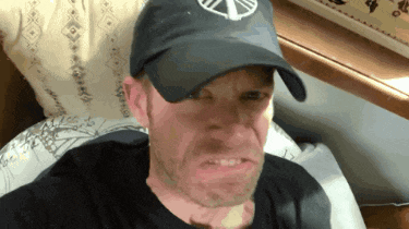 a man wearing a hat that has a peace sign on it