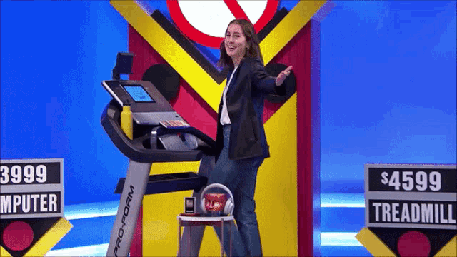 a woman stands in front of a proform treadmill with a price tag of $ 4599