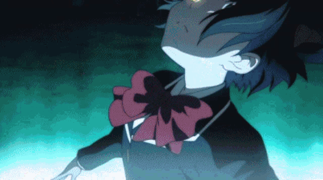 a girl in a school uniform with a red bow on her neck