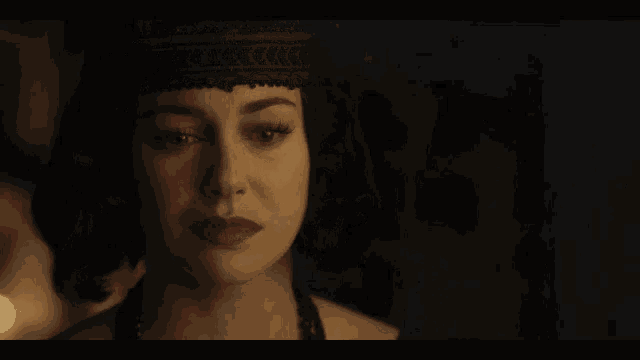 a close up of a woman 's face with her eyes closed and red lips .