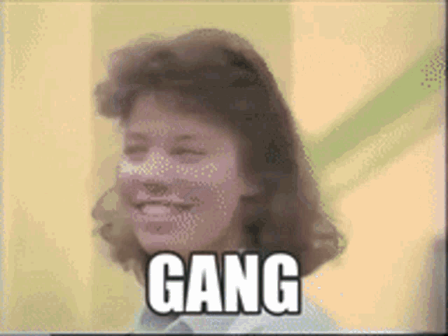 a woman is smiling with the word gang above her head