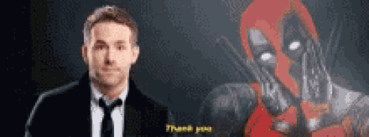 a man in a suit and tie is standing next to a deadpool superhero .