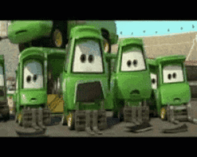 a group of green cartoon vehicles with white faces are standing next to each other