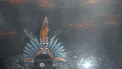 a person wearing a feathered headdress with a ring on their finger