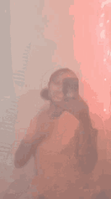 a woman is taking a picture of herself in a mirror .