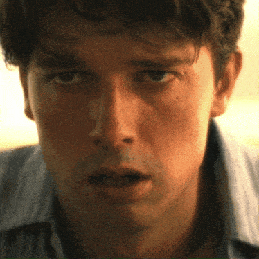 a close up of a man 's face with a very serious look on his face