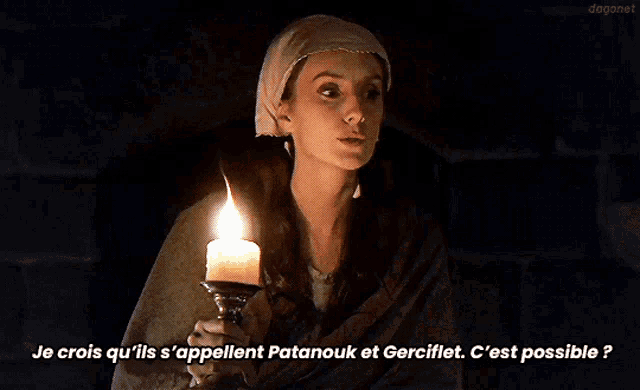 a woman is holding a lit candle and says je crois qu'ils s'appellent patanouk et gercillet