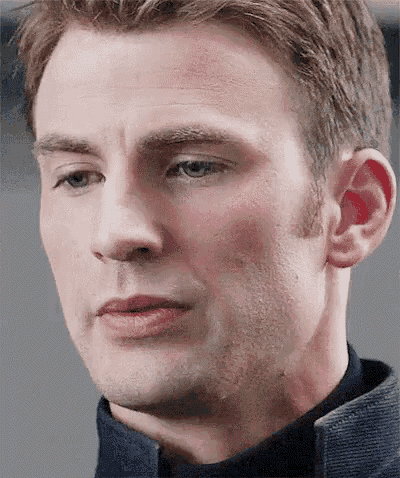 a close up of a man 's face with a blue shirt on .