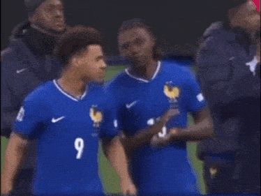 a soccer player wearing a blue jersey with the number 13 on it