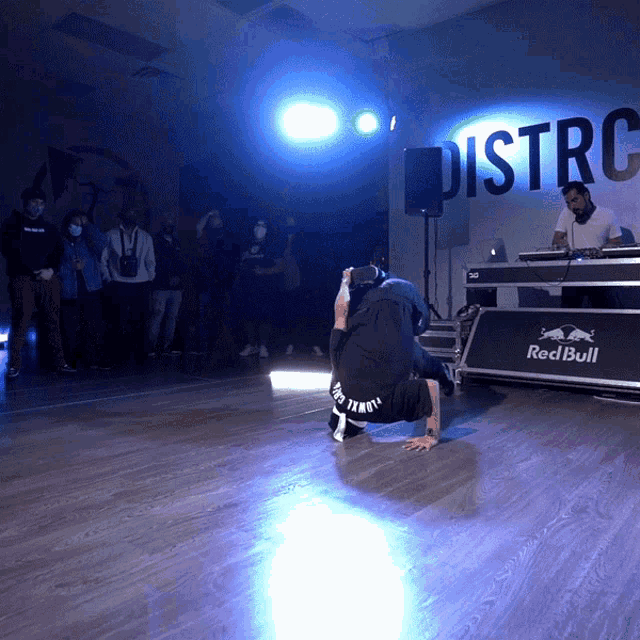 a man kneeling down in front of a sign that says district