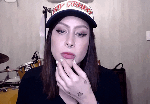 a girl wearing a hat that says bad brains