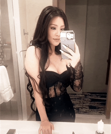 a woman taking a picture of herself in a mirror with an iphone case
