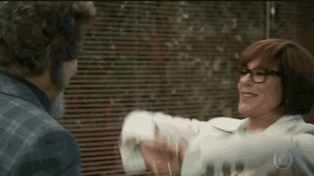 a man and woman are shaking hands in front of a blind