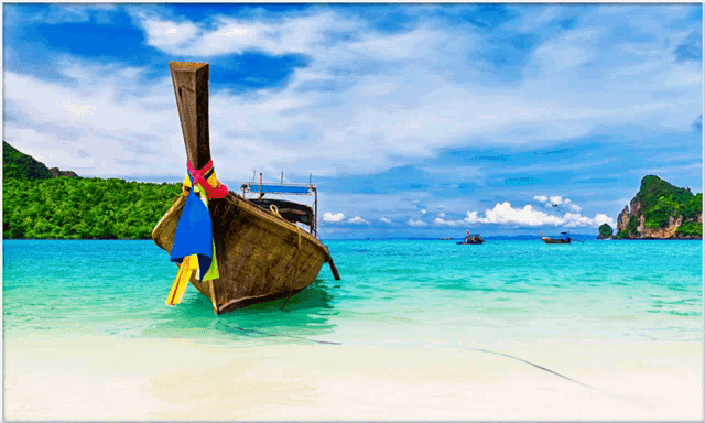 a boat with a long tail is sitting on the beach