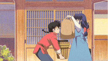 a man and a woman are standing in front of a wooden door .