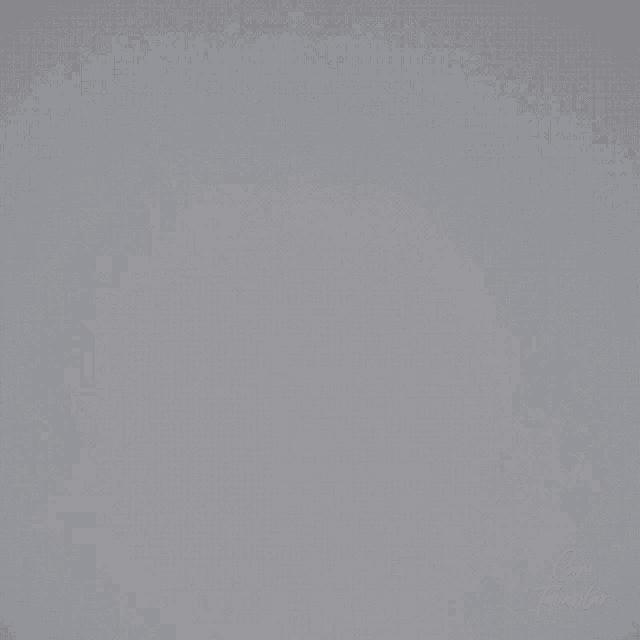a man with a beard is standing in front of a white wall with the word coma written on it