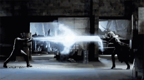 a man and a woman are fighting with a light coming out of their hands