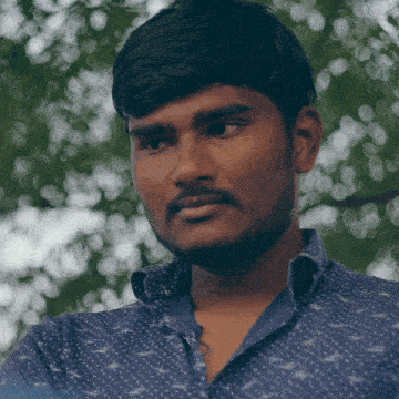 a man with a beard wearing a blue shirt