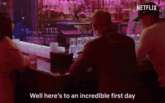 a man sits at a bar with the words well here 's to an incredible first day on the bottom